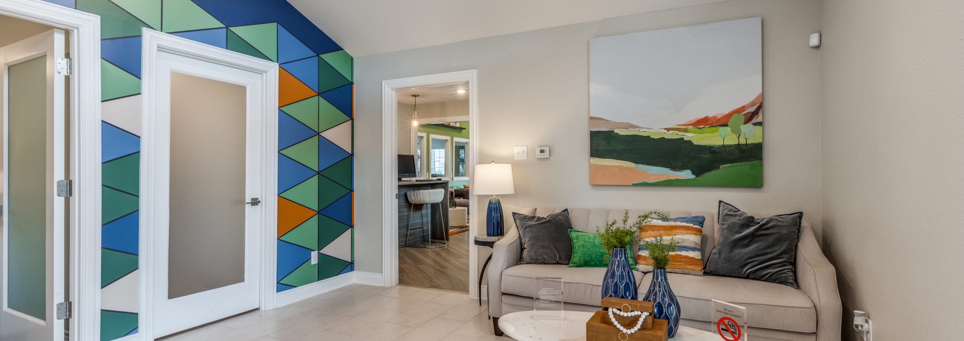 a living room with a colorful mural on the wall at The  Argyle