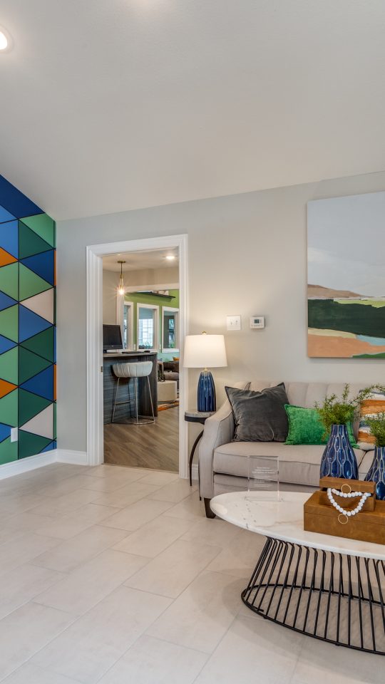 a living room with a colorful mural on the wall at The  Argyle